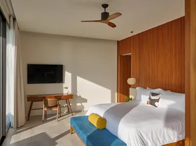 a bedroom with a large bed and a desk at Casa Alma by Elite Havens in Nai Harn Beach
