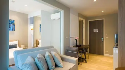 a room with a couch and a bed and a table at Diamond Apartment with Terrace near Bang Tao Beach in Bang Tao Beach
