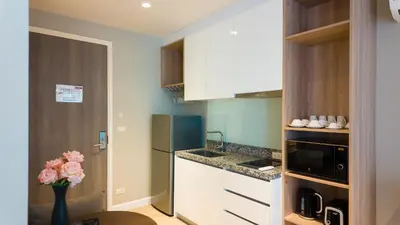 a small kitchen with a refrigerator and a counter at Diamond Apartment with Terrace near Bang Tao Beach in Bang Tao Beach