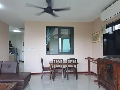 a living room with a dining room table and a ceiling fan at Seaview Eagles Nest Apartments in Rawai Beach