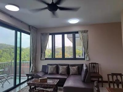 a living room with a couch and a ceiling fan at Seaview Eagles Nest Apartments in Rawai Beach