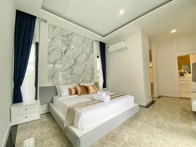 a bedroom with a white bed with a large window at Menara - 3 BR Private Pool Villa - Moroccan Inspired - Bangtao Beach in Phuket Town