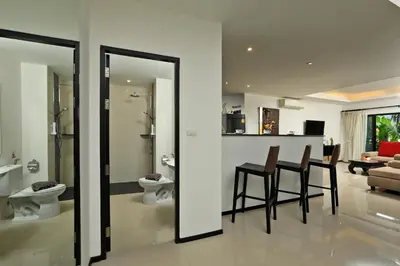 a kitchen and living room with a table and chairs at Thaimond Residence by TropicLook Walkable distance to Naiharn beach in Nai Harn Beach