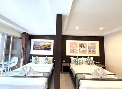 a room with two beds with pillows on them at Thai Classic House in Patong Beach