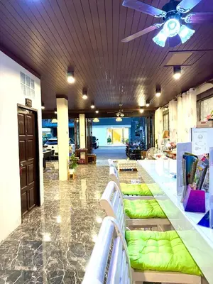 a store with green seats in a room with a ceiling at Thai Classic House in Patong Beach