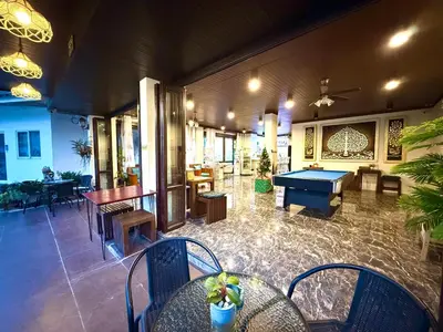 a lobby with a pool table and tables and chairs at Thai Classic House in Patong Beach
