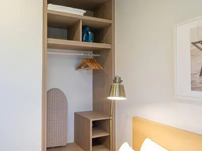 a room with a bed and a lamp and shelves at 2 спальни Апартаменты на Бангтао 600 метров от моря in Bang Tao Beach