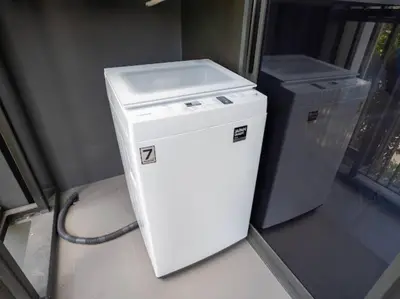a small white refrigerator sitting next to a gray cpu at 2 спальни Апартаменты на Бангтао 600 метров от моря in Bang Tao Beach