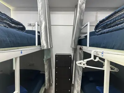 two bunk beds in a dorm room with blue beds at Sweed Dee Seaview Hostel in Phi Phi Don