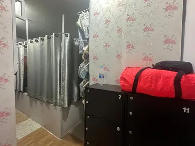 a bedroom with a red bed and a shower at Sweed Dee Seaview Hostel in Phi Phi Don