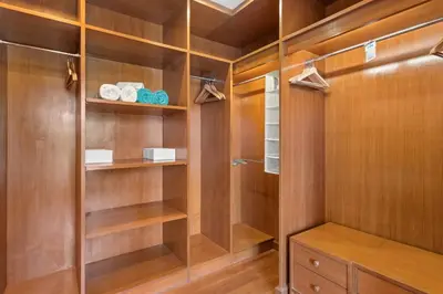 a walk in closet with wood paneling and shelves at Laguna Lakeview Villa in Layan Beach