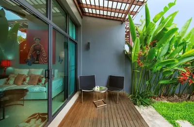 a patio with a couch and a table and some plants at Вилла с бассейном на Най Харн, 2 спальни G3 in Rawai Beach