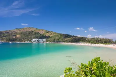 a beach with turquoise water and a mountain at 2BR Pool Villa&Garden - Bali style by La Perla Phuket Rawai in Ban Saiyuan (1)