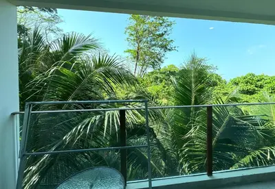 a balcony with a view of palm trees at Private apartment at Oceana Resort by Lofty in Kamala Beach
