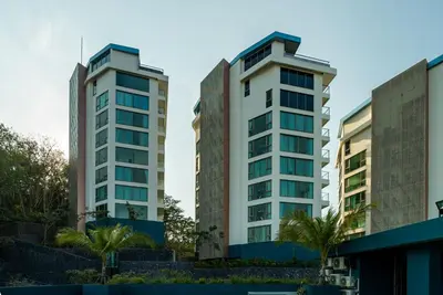 two tall buildings with palm trees in front of them at Private apartment at Oceana Resort by Lofty in Kamala Beach