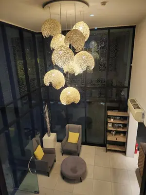 a room with chairs and chandeliers in a store at 中央公寓 1 bed & Twin beds in Ban Rangeng