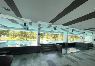 a building with a pool in the middle of it at Private apartment Zcape2 near Boat Avenue in Bang Tao Beach
