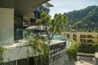 a building with a tree on the side of it at Private apartment at Twin Sands by Lofty in Patong Beach