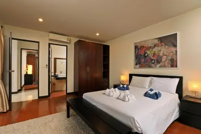 a bedroom with a large bed with two towels on it at VILLA Salika Thai Balinese pool villa RAWAI in Rawai Beach