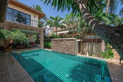 a swimming pool in front of a house at VILLA Salika Thai Balinese pool villa RAWAI in Rawai Beach