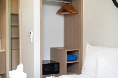 a bedroom with a bed and a closet at Laguna BangTao Beach Skypark Apartment in Phuket Town