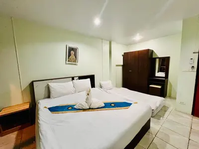 a hotel room with a bed with a towel on it at BLUE PEARL SHORE in Patong Beach