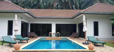 a swimming pool with two chairs and a house at Wow !! Super Cool !! Jungle View Pool Villa !! Krabi - Thailand in Krabi town