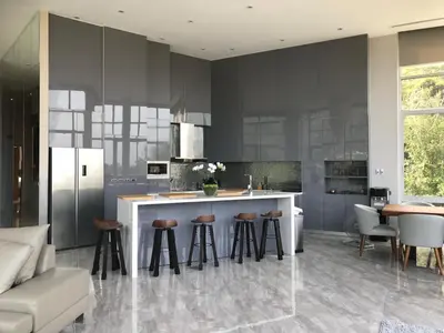 a kitchen with a island with bar stools in it at 360* Ultimate Penthouse Entire TOP FLOOR and RESORT with GREAT AMENITIES in Kamala Beach
