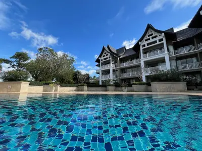 a large swimming pool in front of a building at Stylish 1 Bedroom Apartment with Golf View, Steps from Bang Tao Beach, Allamanda Laguna in Bang Tao Beach