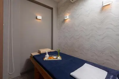 a room with a blue bed with a tray on it at Summer Estate Villa in Pilai Beach