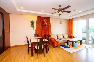 a living room with a couch and a table at Seaside Haven Karon in Karon Beach