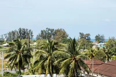 a group of palm trees in a city at Tropics Kamala Hill View Apartment CTG D709, near Beach and Fantasea in Kamala Beach