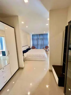 a white bedroom with a bed and a window at Chez Wanida - apartment Krabi in Klong Muang Beach