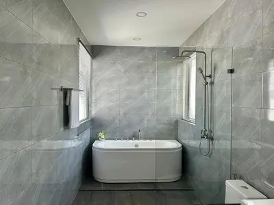 a bathroom with a white tub and a shower at Costa Lota villa, brand new, 3 bedroom, in rawai V35 in Rawai Beach
