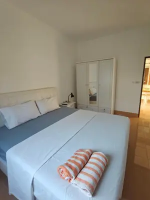 a large white bed with two pillows on it at Rawai-Casevacanze in Rawai Beach