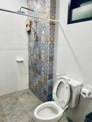 a bathroom with a toilet and a shower at Hm House Patong in Patong Beach