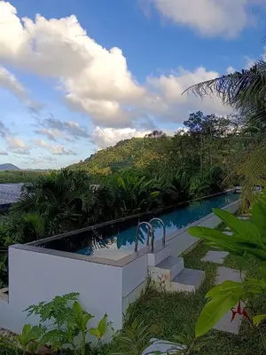 a swimming pool in the middle of a resort at Sky Lofts Phuket in Nai Yang Beach