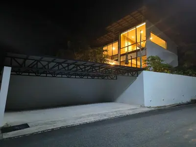 a building with a balcony on the side of it at Sky Lofts Phuket in Nai Yang Beach