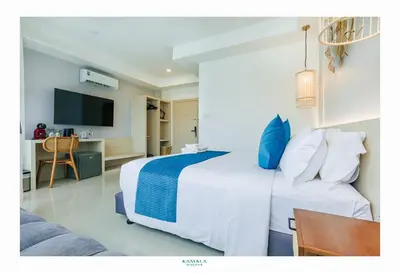 a hotel room with a bed and a desk at Kamala Havana Hotel and Cafe in Kamala Beach