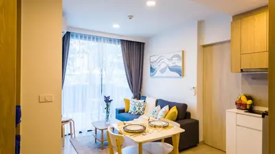 a living room with a table and a couch at Апартаменты в Laguna Skypark с террасой in Bang Tao Beach