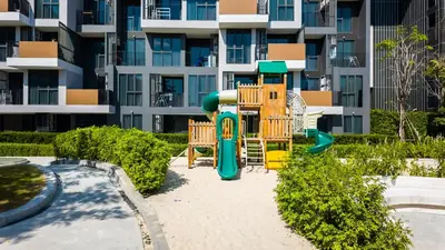 a playground in front of a apartment building at Апартаменты в Laguna Skypark с террасой in Bang Tao Beach