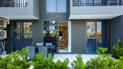 a house with glass doors and a patio at Апартаменты в Laguna Skypark с террасой in Bang Tao Beach