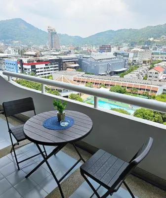 a table and chairs on a balcony with a view at Patong Tower Apartment in Patong Beach
