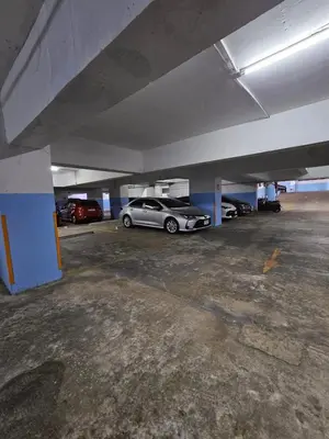an empty parking garage with cars parked in it at Patong Tower Apartment in Patong Beach