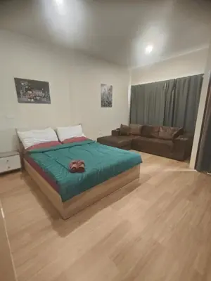 a bedroom with a bed and a couch at Bonanza Patong Beach1 100m to Beach Sun Room in Patong Beach