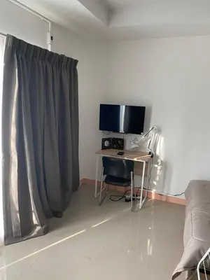a room with a desk with a computer and a monitor at Studio Apartment in Phuket Town