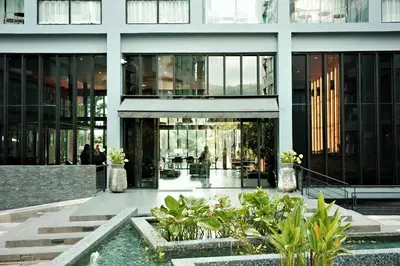 a building with a courtyard with plants in front of it at City Gate Kamala N303 by Phuket Sabay Rent in Phuket Town