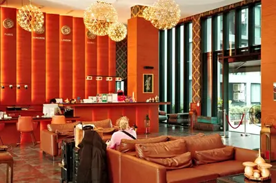 a woman sitting on a couch in a lobby at City Gate Kamala N303 by Phuket Sabay Rent in Phuket Town