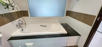 a small bathroom with a sink and a mirror at Diamond Crown Hotel in Patong Beach