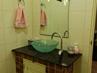 a bathroom with a green bowl sink and a mirror at Natures relax in Kamala Beach